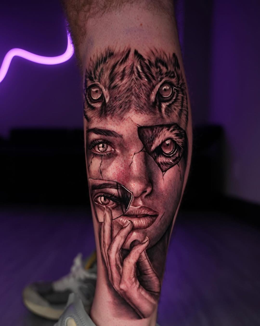 Black and grey surreal woman and tiger face morph tattoo on leg by Ink Theory